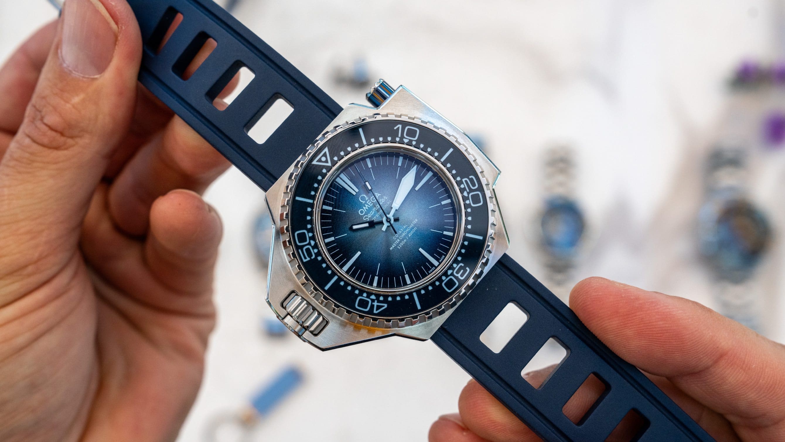 Omega Seamaster Ploprof 1200M in Summer Blue special edition, showing the ceramic bezel and dial
